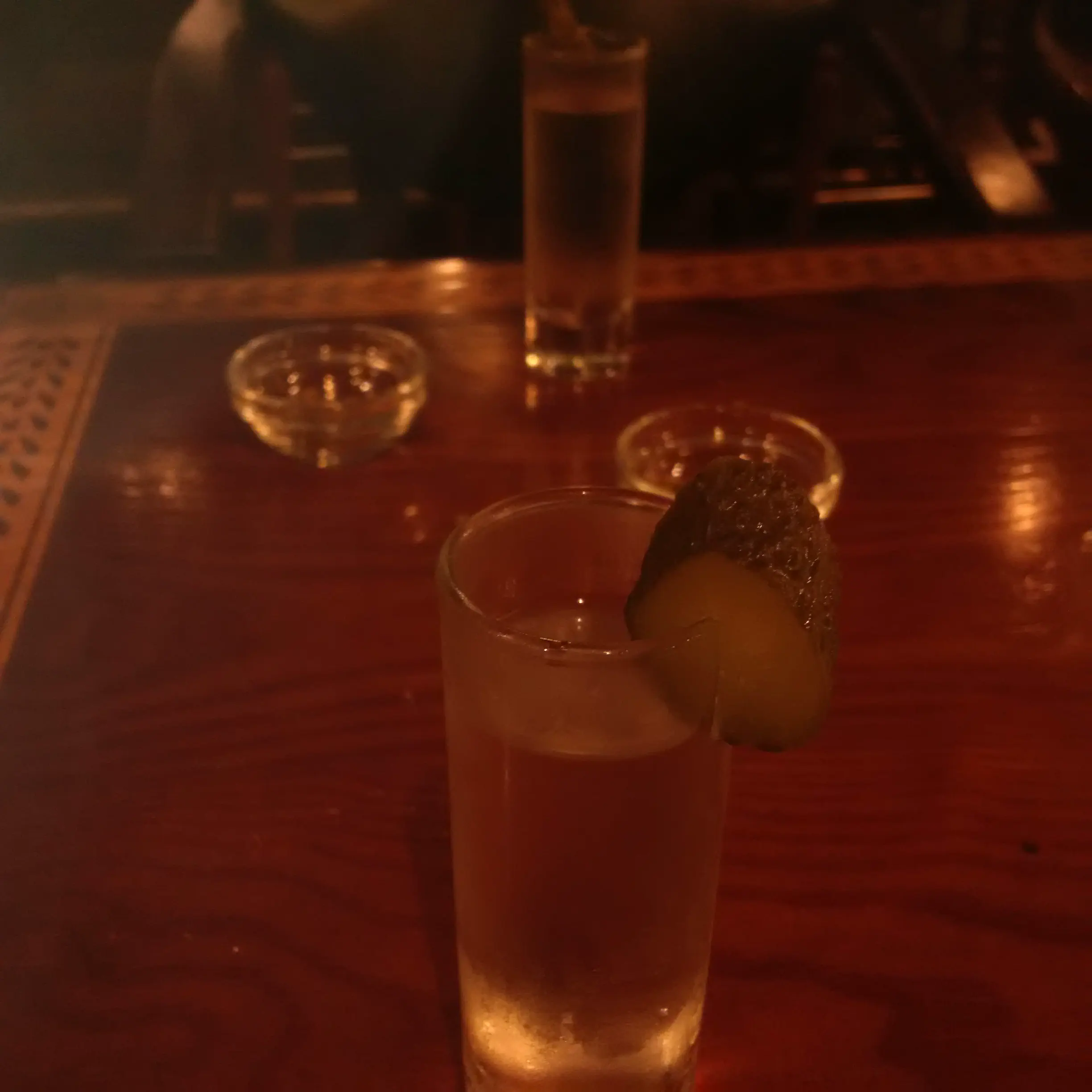 A shot of vodka with a slice of pickle