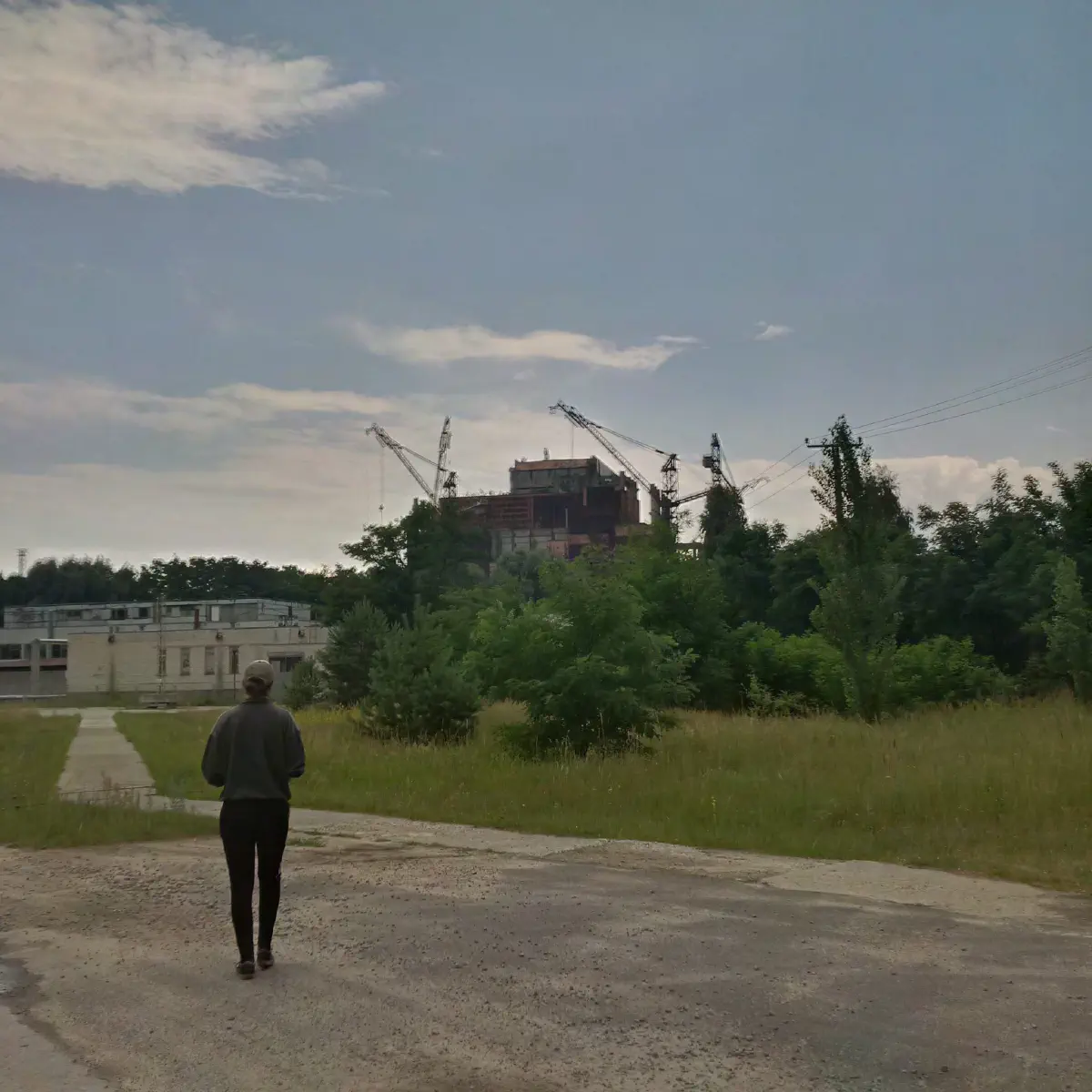 Woman standing in front of the Chernobyl reactor