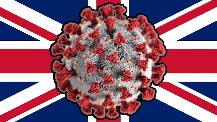 A coronavirus in front of a UK flag