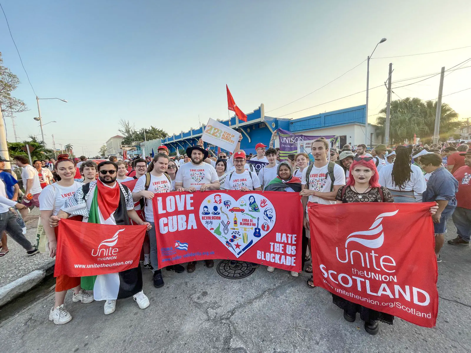 A large group holding a banner that reads ‘love Cuba, hate the US blockade’