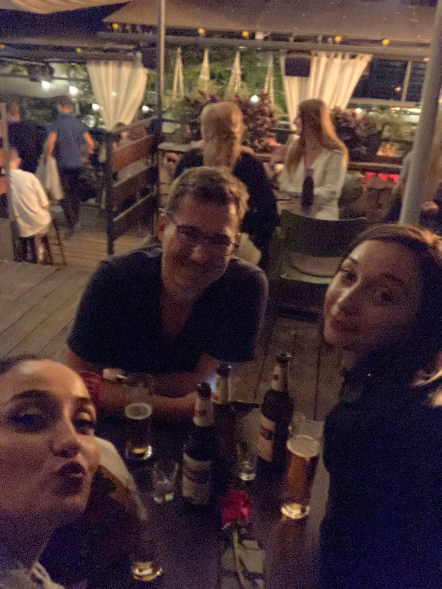 Three people drinking at a bar