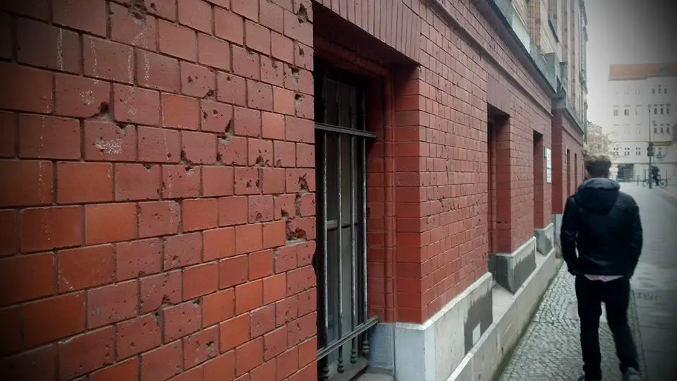 A wall in Berlin, dotted with bullet holes