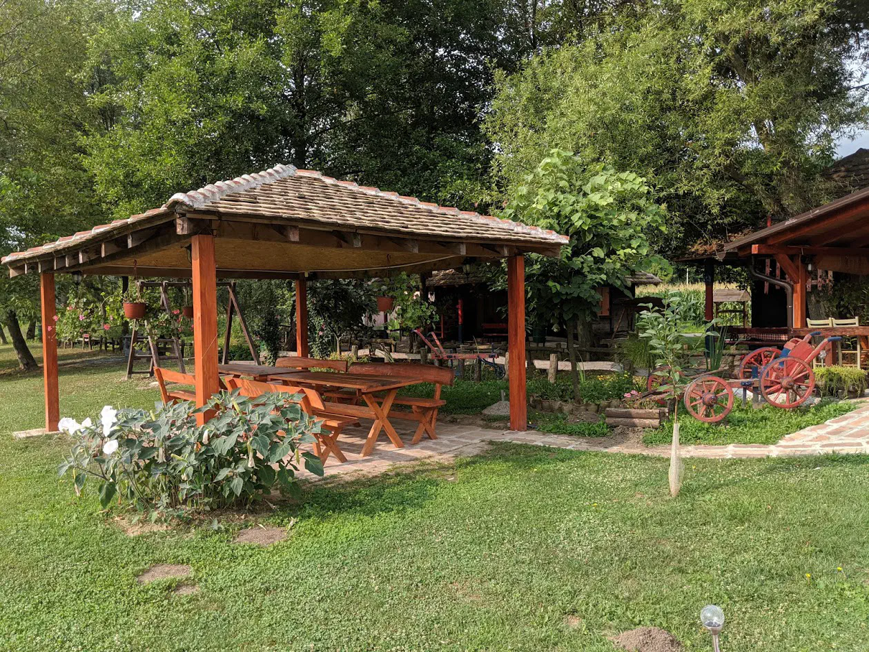 A picnic bench area in a nicely-manicured garden