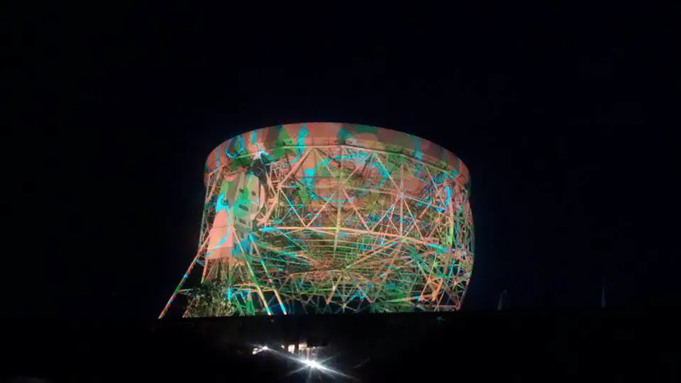 Light installation displayed onto the Jodrell Bank Observatory
