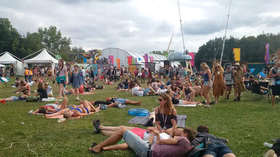People relaxing on the grass inside the main arena