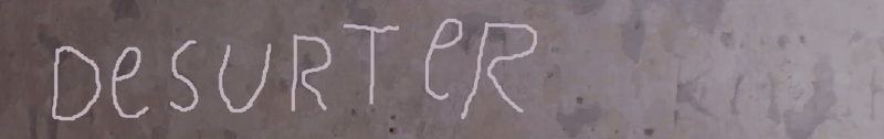 A castle wall with an engraving highlighted reading 'desurter [sic]'