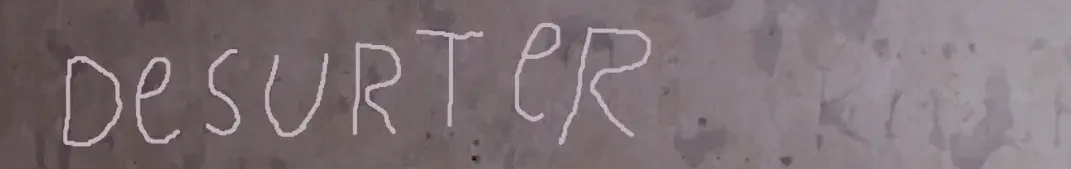 A castle wall with an engraving highlighted reading 'desurter [sic]'