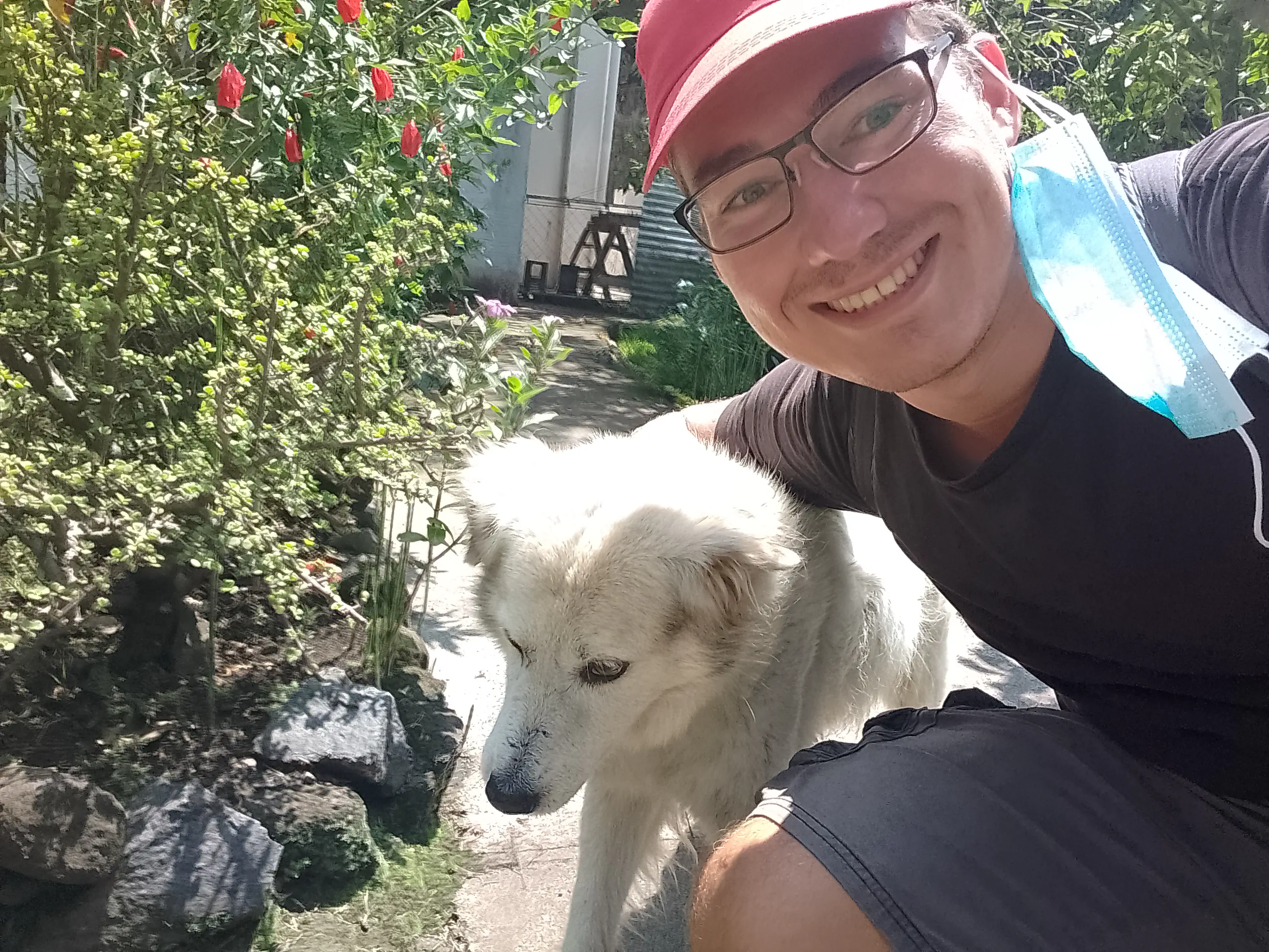 The author taking a selfie with an old white dog