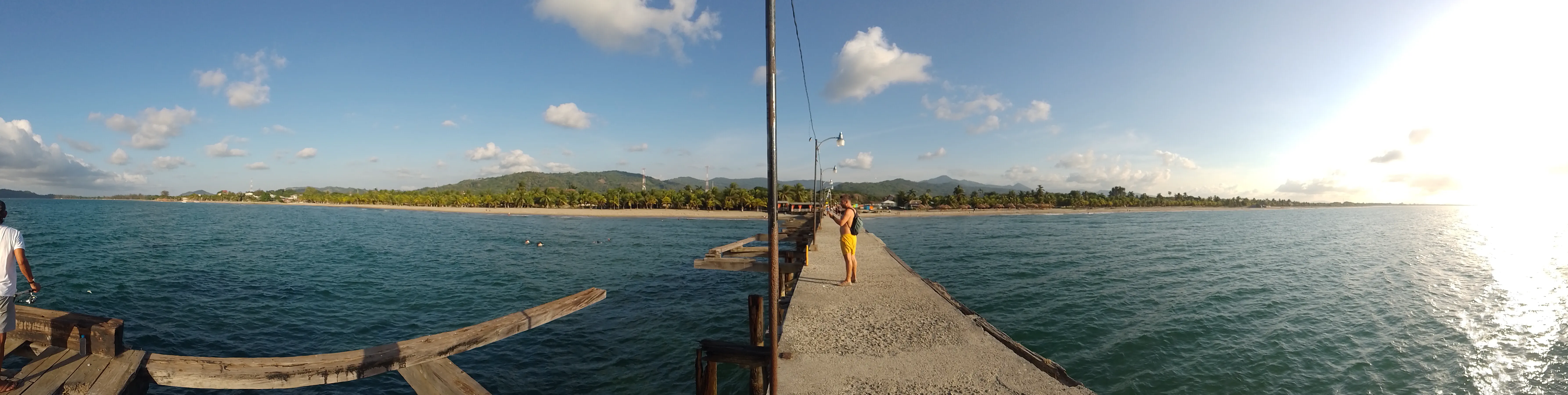 The coast, viewed in panorama from the end of a pier