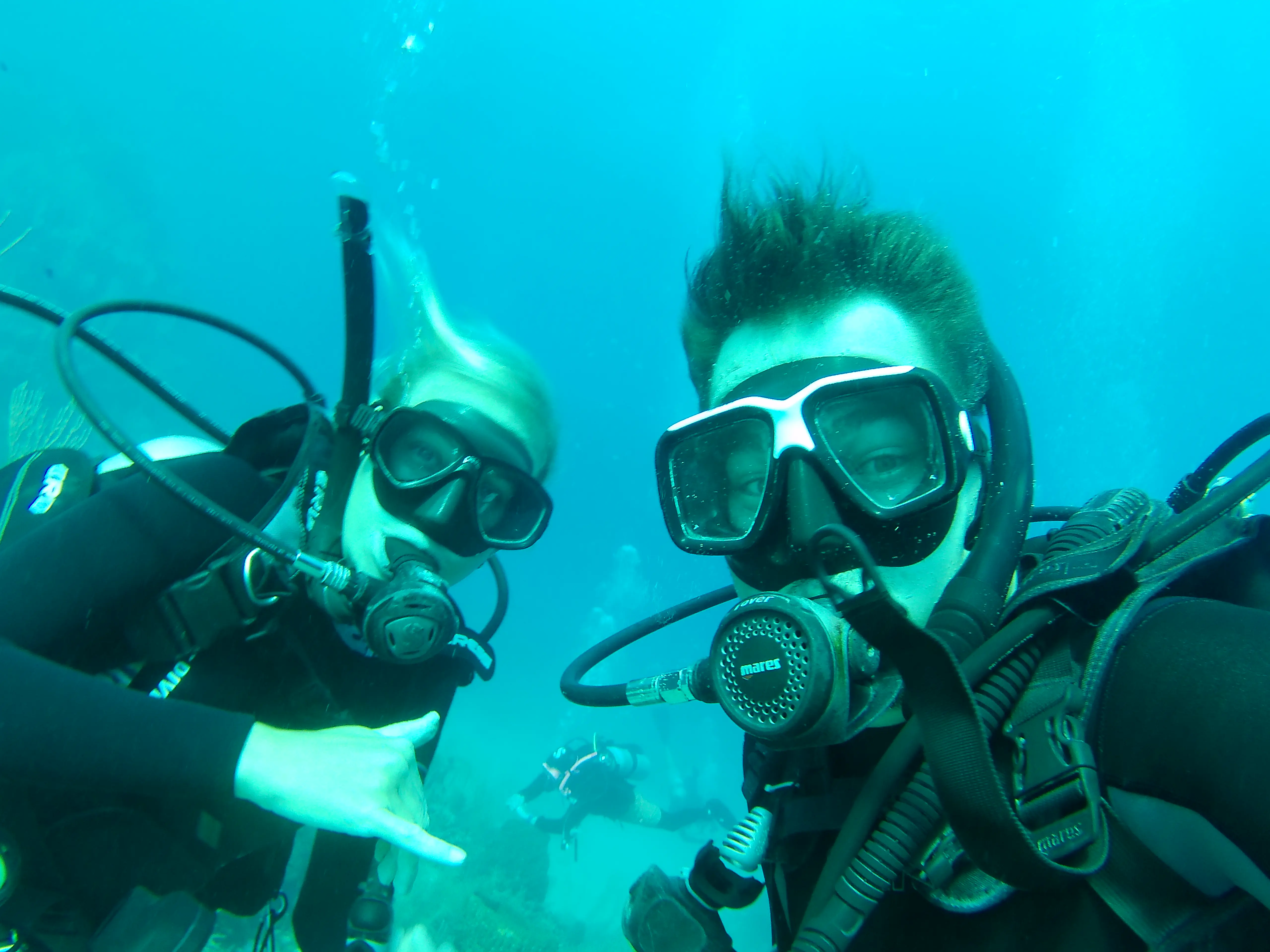 Two people in SCUBA gear, underwater