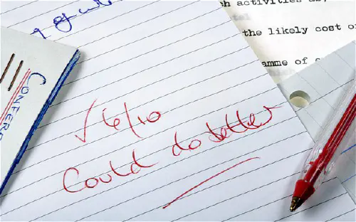 A notebook with '6/10 could do better' written in red ink