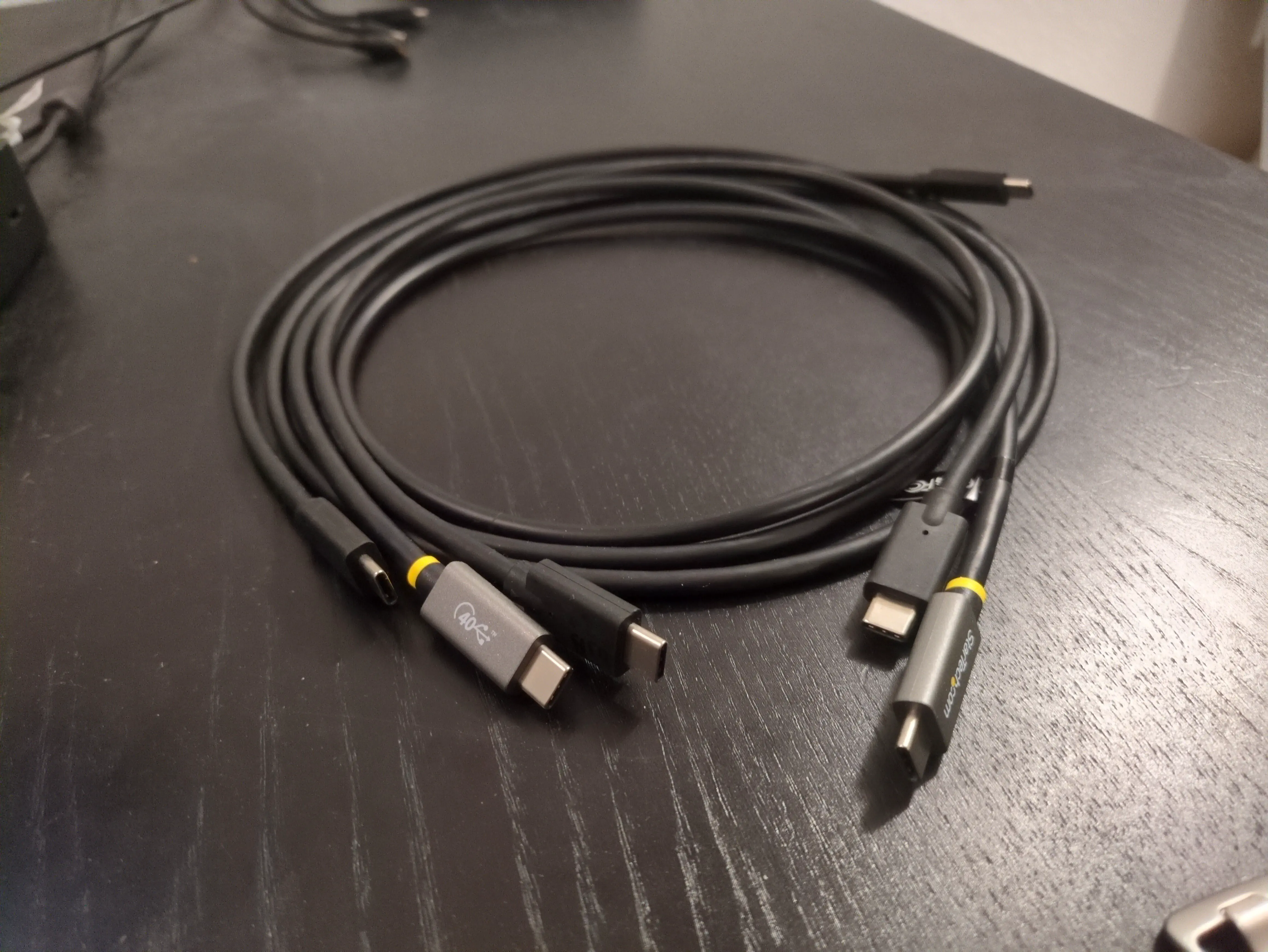 A collection of {{< abbr "usb" >}} cables on a desk