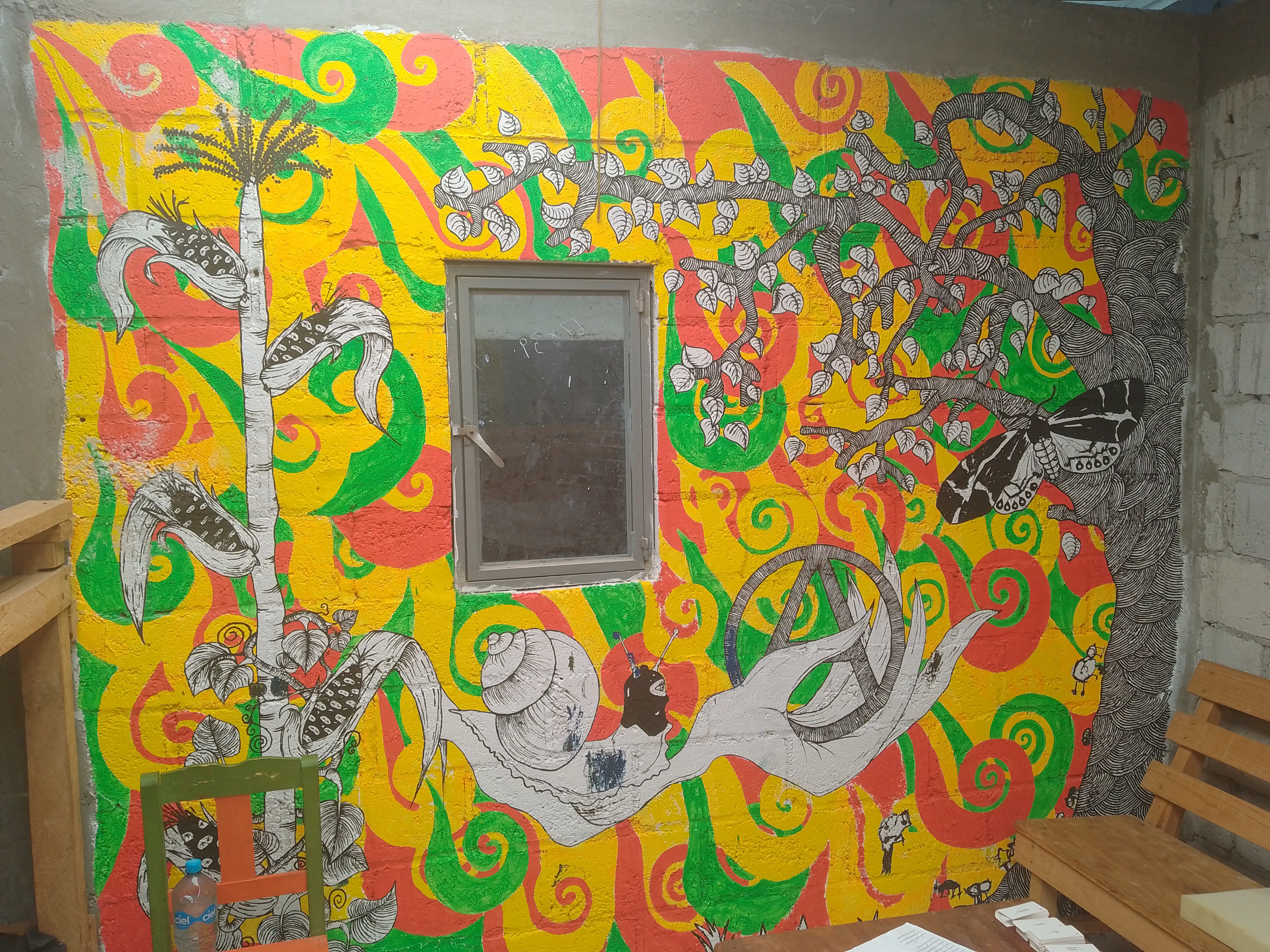 Mural of a hand cradling an anarchy symbol