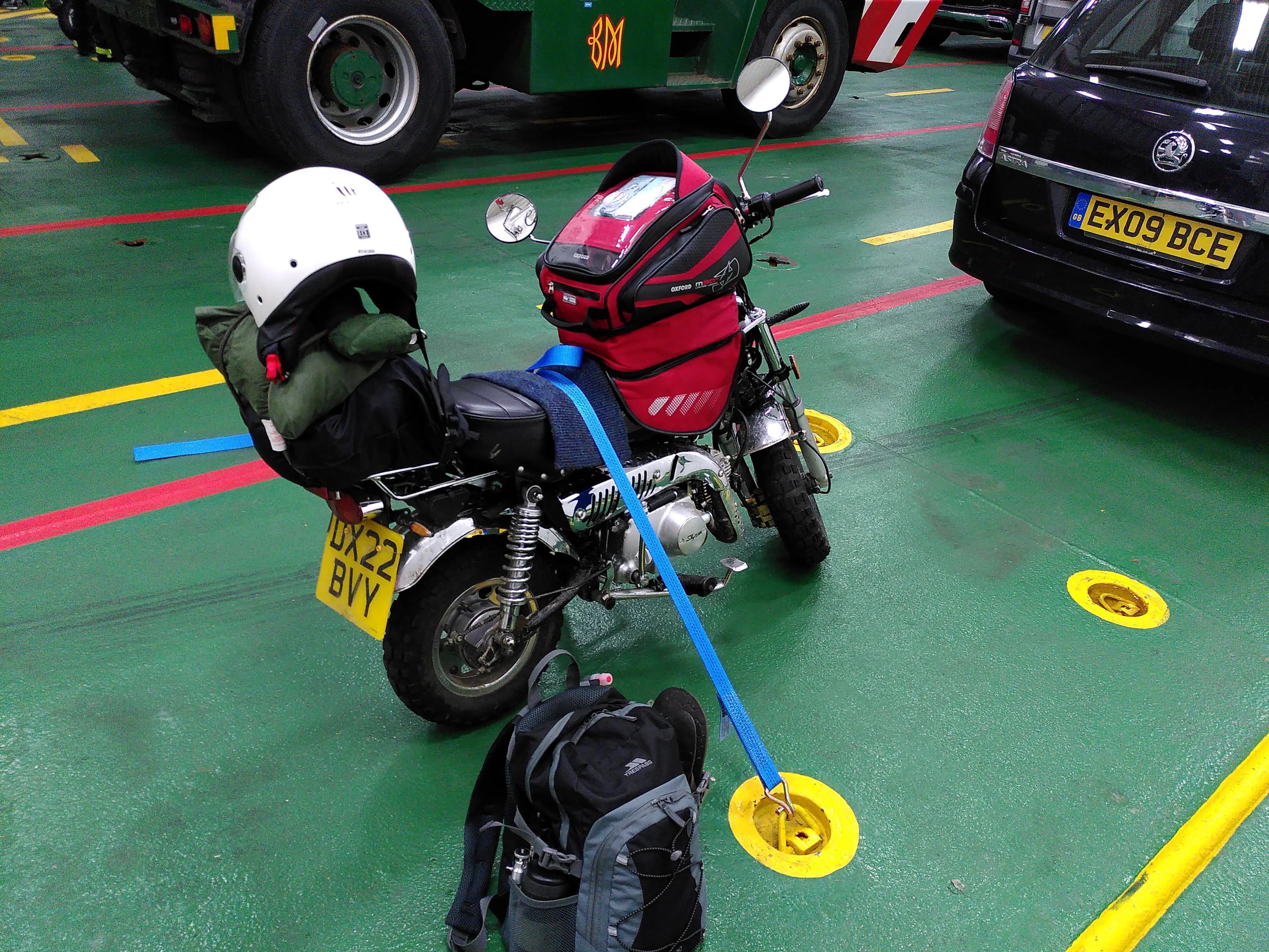 My monkey bike strapped into a ferry's car deck floor