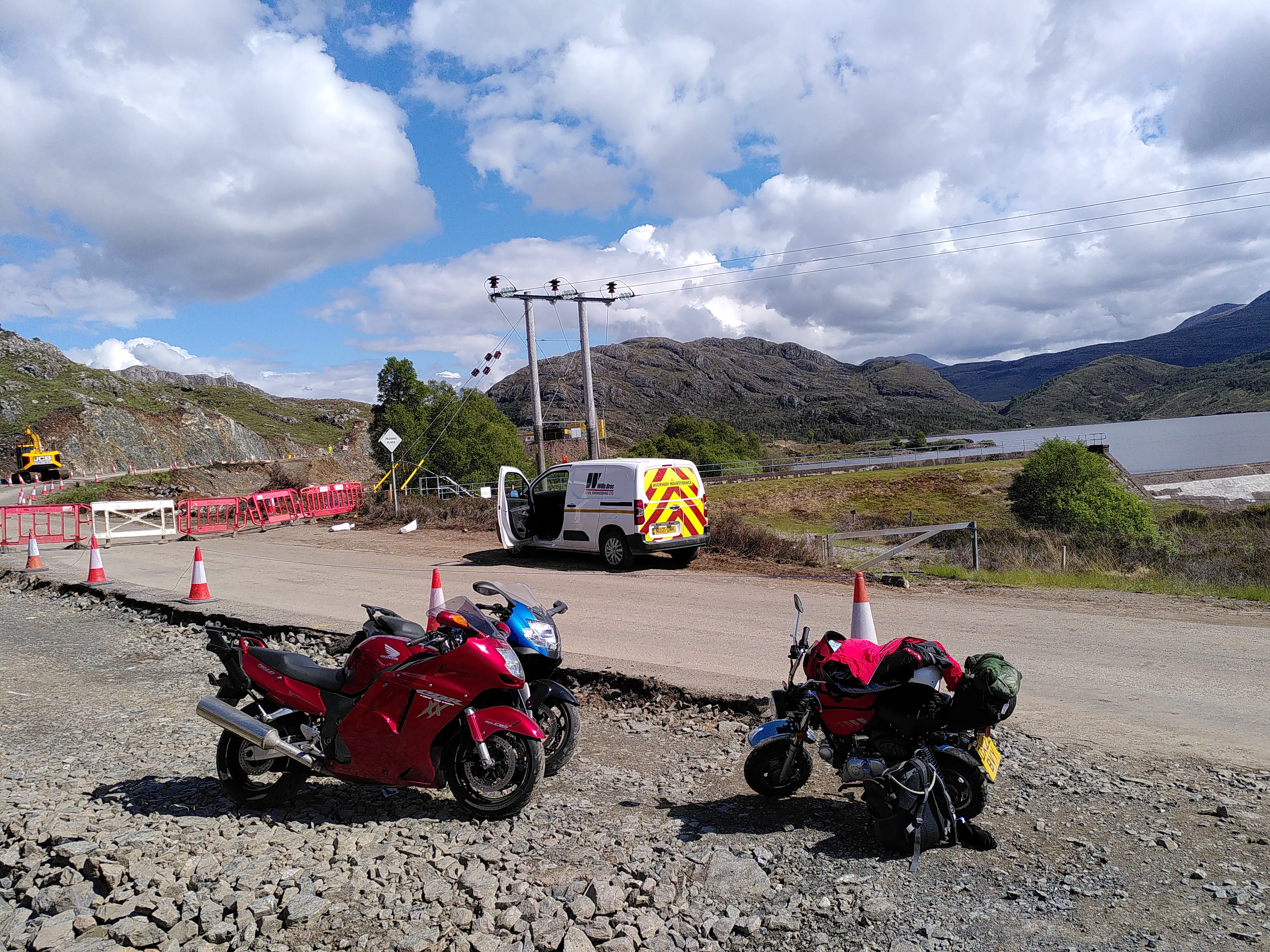 A monkey bike beside a full-sized motorcycle