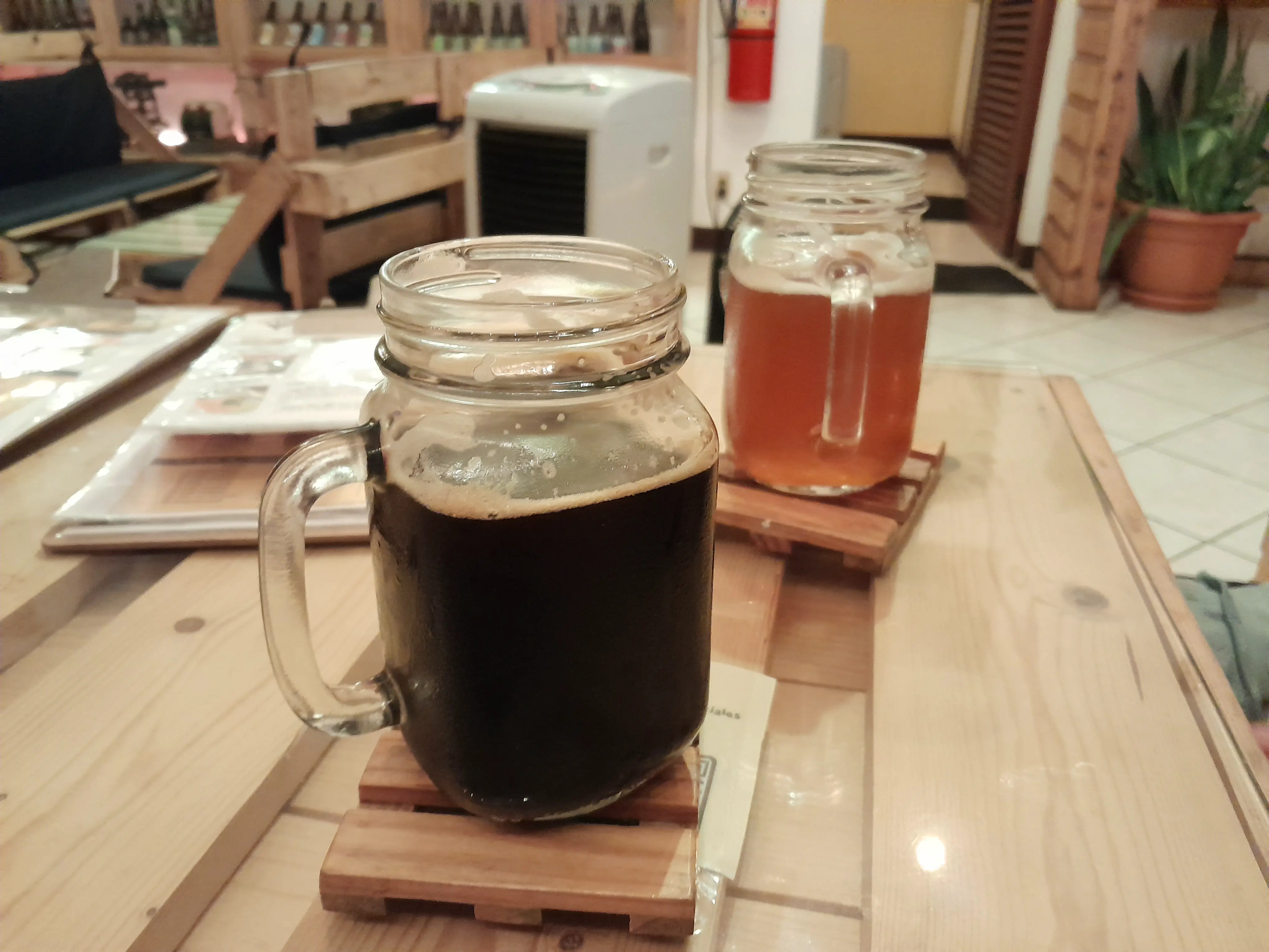 A mason jar filled with dark ale