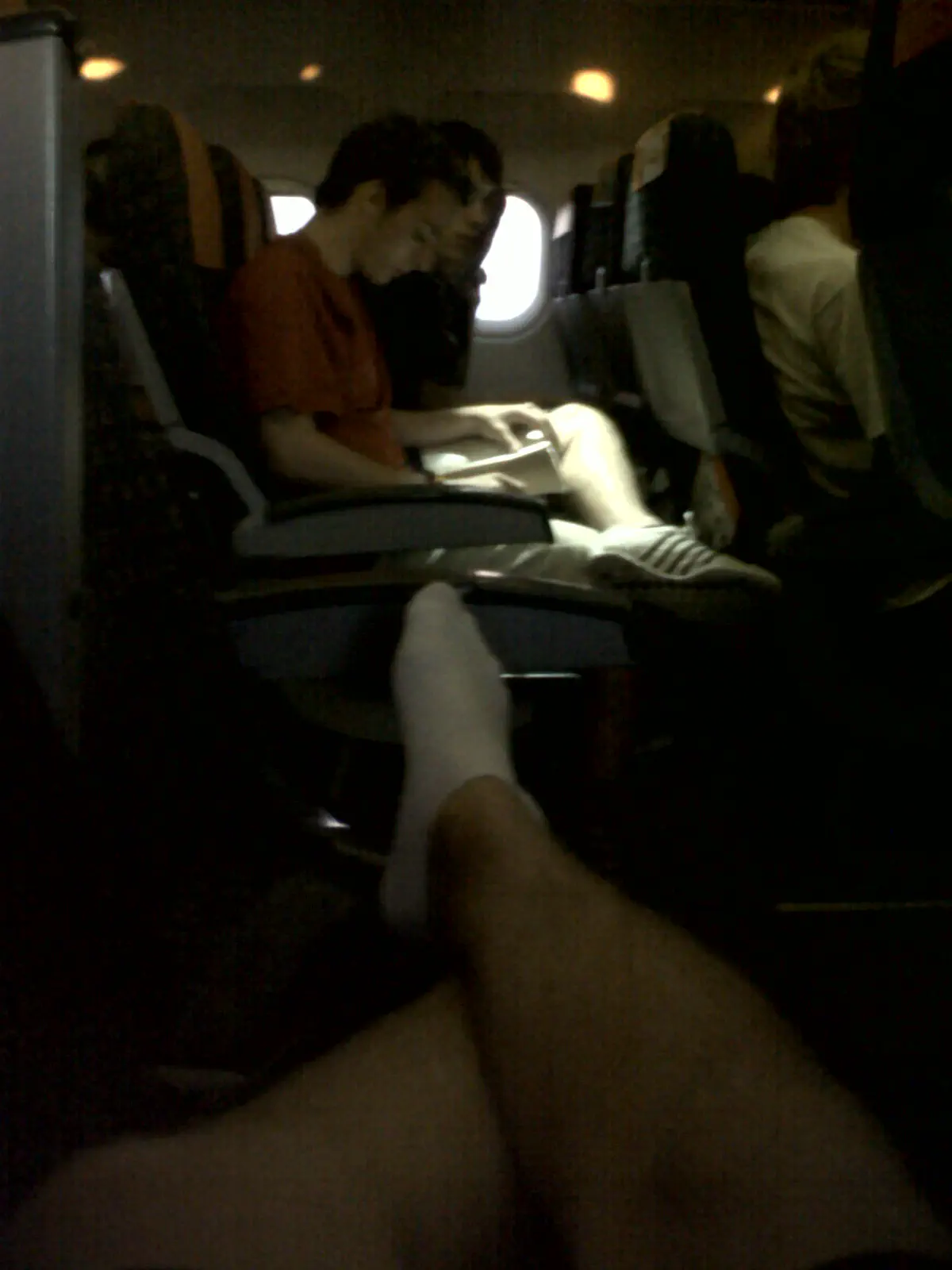 Me lounging across several seats on a plane