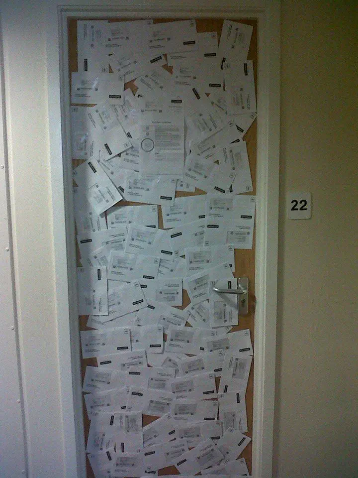 A door covered in letters from TV Licensing