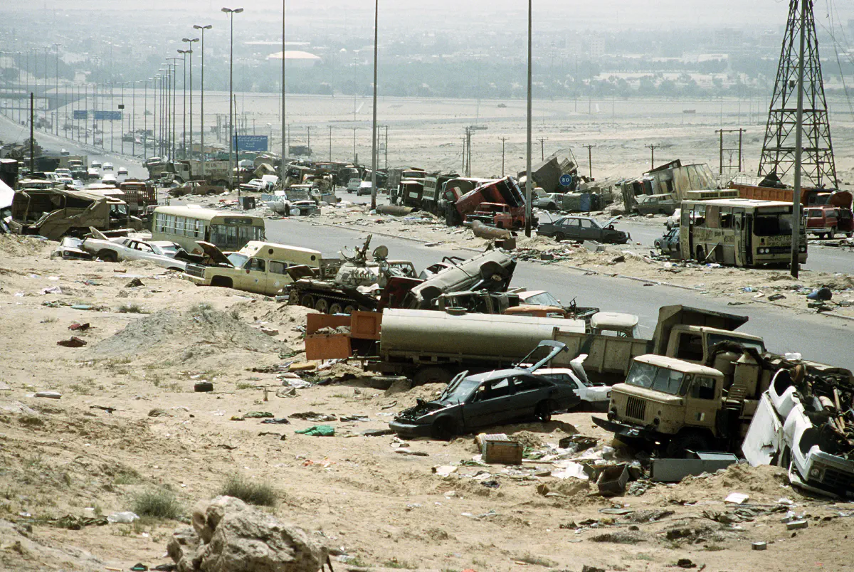 Demolished vehicles line Highway 80, also known as the "Highway of Death", the route fleeing Iraqi forces took as they retreated from Kuwait during Operation Desert Storm.