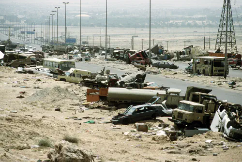 Demolished vehicles line Highway 80, also known as the "Highway of Death", the route fleeing Iraqi forces took as they retreated from Kuwait during Operation Desert Storm.