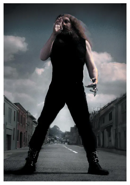 Dramatic photo of Alan Moore standing in a Northampton street