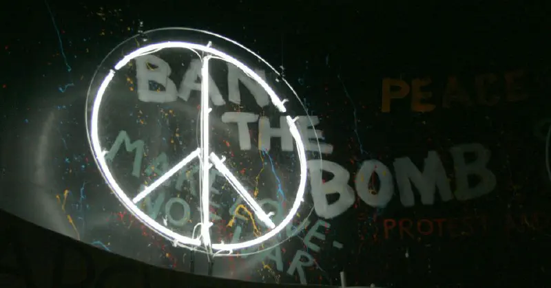 CND symbol in front of graffiti reading 'Ban the bomb'