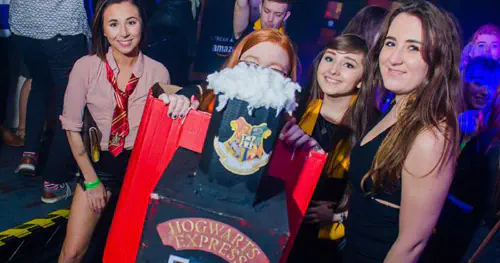 Group of students in a club, with one dressed as the Hogwarts Express train
