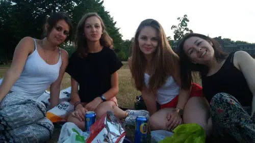Group of women sitting on the grass in a park