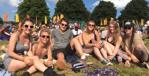 Group of people laying in the grass at a festival