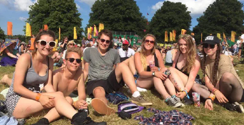 Group of people laying in the grass at a festival