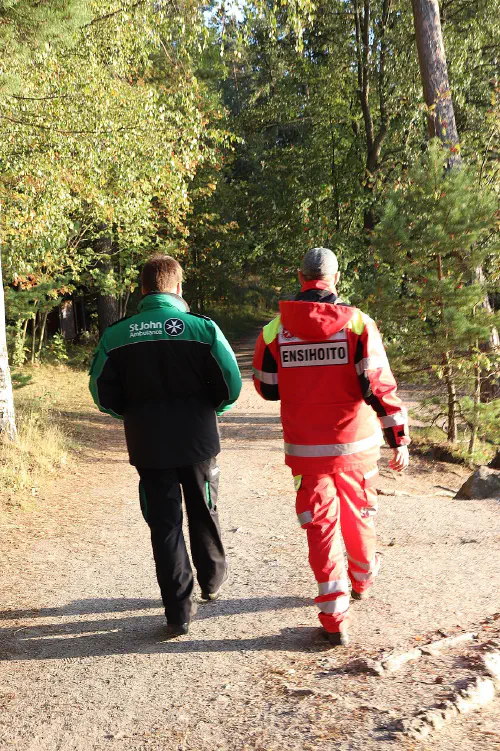St John Ambulance and Johanniter Finland volunteer walking away from camera