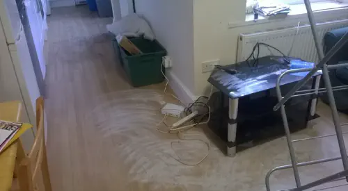 A living room with dusty powder covering the floor