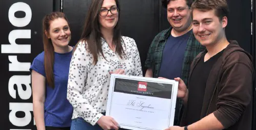 The author handing a Tab-branded certificate to the managers of the Sugarhouse